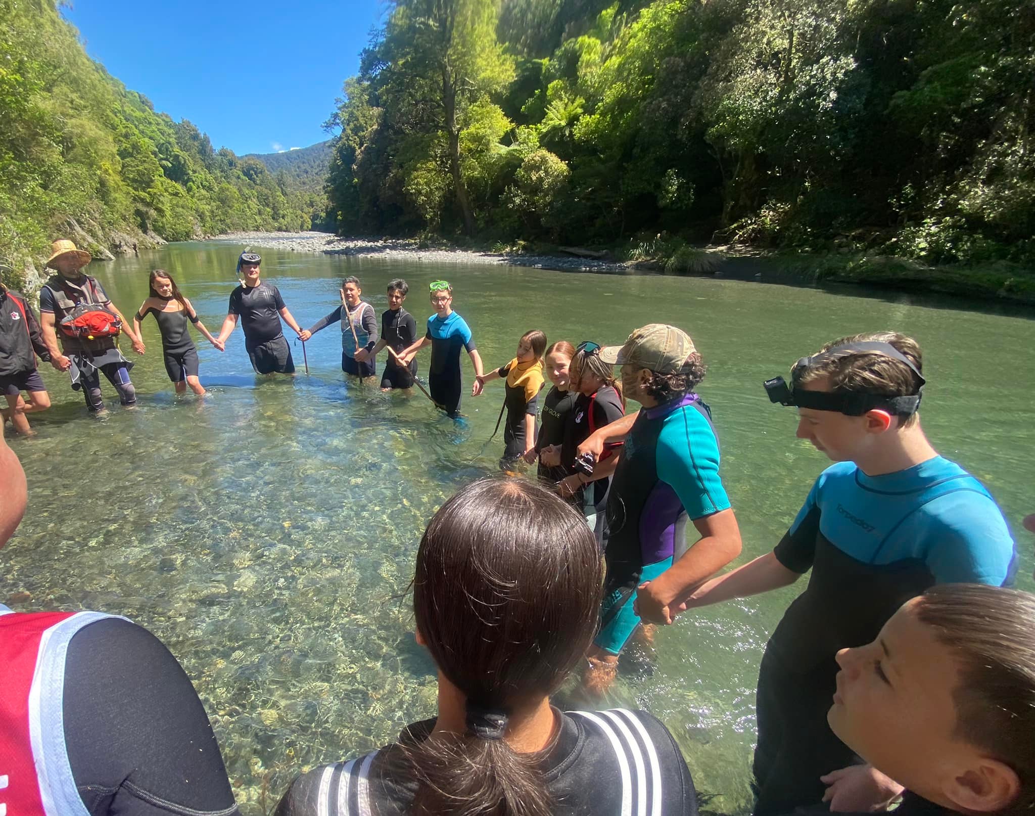 Students standing in the Ruamahanga River